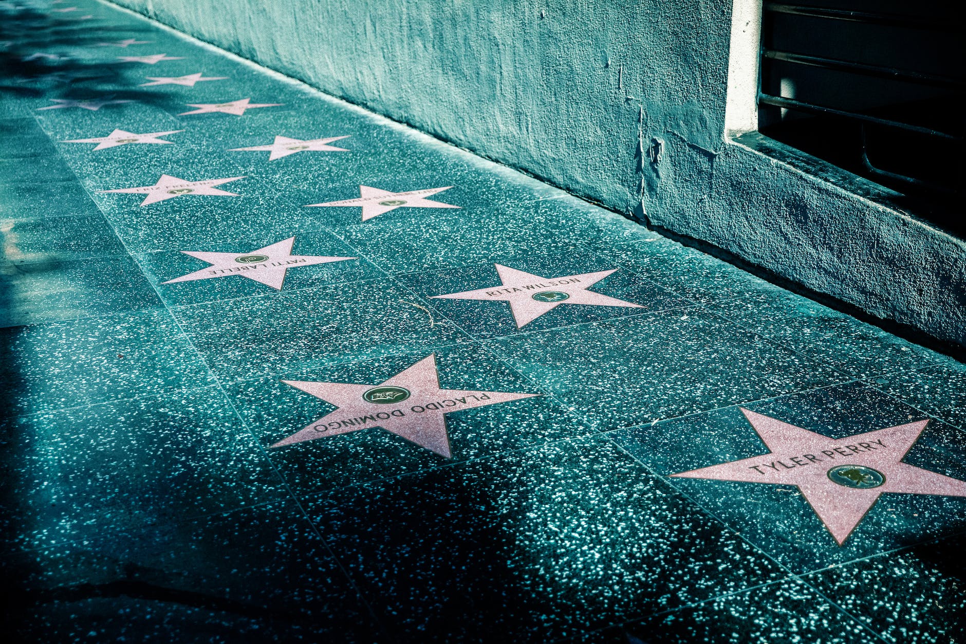 pink stars on gray tiled street sidewalk